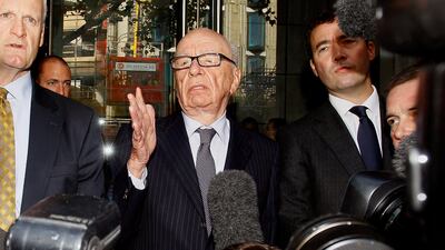 Rupert Murdoch, centre, attempts to speak to the media after he held a meeting with the parents and sister of murdered school girl Milly Dowler in London, Friday, July 15, 2011. The lawyer for Milly Dowler's family says Rupert Murdoch has issued a full and sincere apology to the murdered schoolgirl's family for the actions of journalists at his newspaper. Mark Lewis told reporters that the media baron called the private meeting and apologized "many times," telling the Dowlers the events that transpired at the News of the World tabloid were not in keeping with the standards set out when his own father entered the media industry. (AP Photo/Kirsty Wigglesworth) *** Local Caption *** APTOPIX Britain Phone Hacking.JPEG-0d98b.jpg
