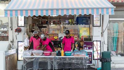Employees of Bait Al Shay fry pakoras and samosas to sell to hungry customers. Antonie Robertson / The National