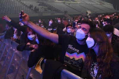 A couple take a selfie as they wait for the start of a rock music concert in Barcelona, Spain. Wearing face masks was obligatory at the concert. AFP