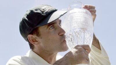 Australia's Justin Langer kisses the Ashes trophy as he celebrates winning the cricket series against England. Former test opener Langer was confirmed as the new head coach of the Australian cricket team on Thursday. AP Photo/Rob Griffith