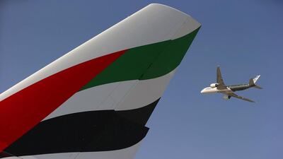 An Airbus A350 XWB flies past the tail fin of an Airbus A380-800 operated by Emirates during an aerial display at the Dubai Airshow. Jasper Juinen / Bloomberg