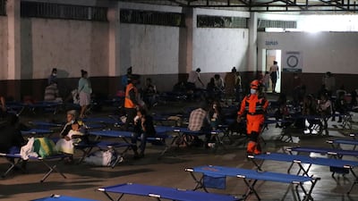 Handout picture released by Bomberos Volutarios shows Firefighters help evacuees settle in a temporary shelter in Santa Lucia Cotzumalguapa south Guatemala City. Some 370 people from a community based at the base of the Fuego volcano, in southwestern Guatemala, were evacuated on Monday following the increase in the volcanic activity of the colossus, the Civil Protection Agency reported. AFP