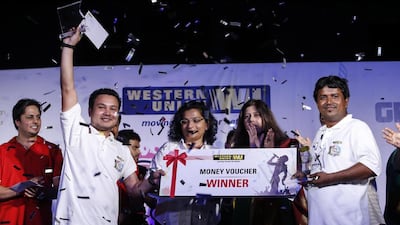 Mohammed Shazad Ali, 32, from India, right, and Kushal Sunar, 22, from Nepal celebrate clinching the Western Union Camp Ka Champ title at the Jiwin Staff Accomodation in Muhaisanah 2, Sonapur. Antonie Robertson / The National