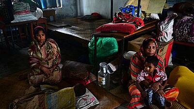 Bangladeshi evacuees wait for Cyclone Mahasen to subside in a shelter in Chittagong. Munir uz Zaman / AFP Photo