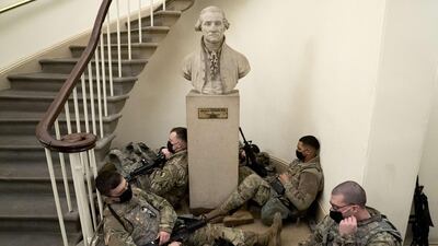 Members of the National Guard rest in the U.S. Capitol in Washington, DC. Security has been increased throughout Washington following the breach of the U.S. Capitol last Wednesday, and leading up to the Presidential inauguration. AFP