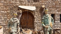 Phoenician warrior statues stand guard outside a municipal building in Dibbin, a village destroyed by Israeli attacks. Nada Homsi / The National