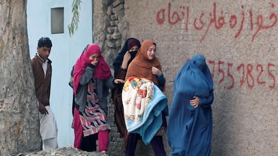 Afghan women move away from the firefight in Jalalabad. Parwiz / Reuters
