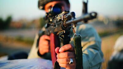 A Kurdish peshmerga fighter observes the front line with Islamic State, in Gwar, northern Iraq on September 23. Ahmed Jadallah / Reuters