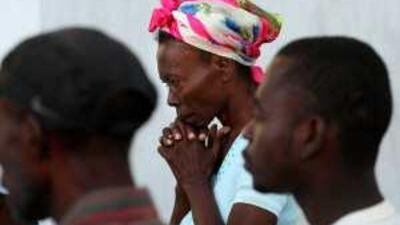 Haitians pray during a mass organised by the priest of the destroyed cathedral of Port-au-Prince yesterday.