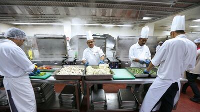 Chefs prepare food inside the kitchen at Dubai World Trade Centre in Dubai. Pawan Singh / The National