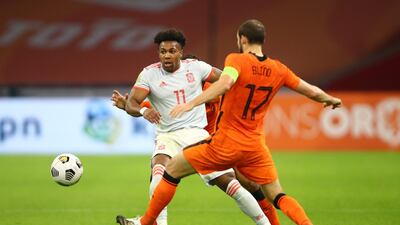 Spain winger Adama Traore is challenged by Owen Wijndal. Getty Images