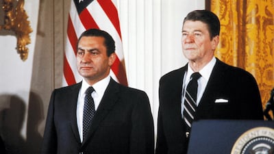 US President Ronald Reagan with Mubarak attend the arrival ceremonies in the east room of the White House on February 3, 1982 in Washington DC. AFP