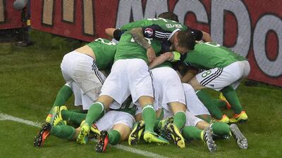 Northern Ireland players celebrate after defender Gareth McAuley gave them a 49th-minute lead courtesy of a header. Jean-Philippe Ksiazek / AFP