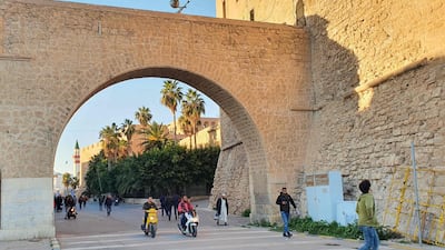 Libyans commute through an archway of the capital Tripoli's Red Castle (Al-Saraya al-Hamra). AFP