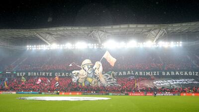 Trabzonspor fans display banners and Turkey flags inside the stadium before the match. Reuters