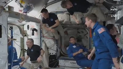 AlNedayan enters the station for the first time and greets his team mates. Photo: NASA