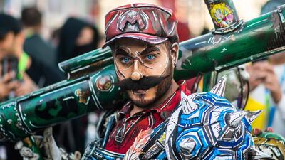 An attendee dressed as Super Mario poses during New York Comic Con. AP