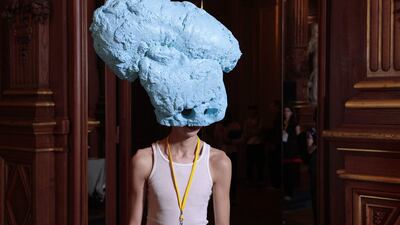 A model in a head-turning outfit waits backstage before a Paris fashion show. AFP
