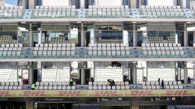 Cleaners sweep the stands where 60,000 viewers will watch the final race of the season. Chris Whiteoak / The National