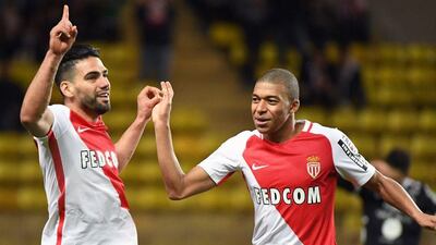Monaco's Colombian forward Radamel Falcao, left, is congratulated by his teammate Kylian Mbappe after scoring a goal during the French Ligue 1 football match against Metz at the Stade Louis II in Monaco on February 11, 2017. Yann Coatsaliou / AFP