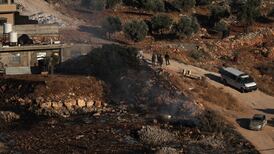 Israeli troops and settlers gather in the occupied West Bank, where Palestinians face almost daily violence. EPA