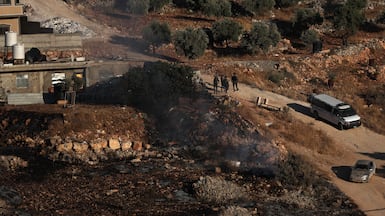 Israeli troops and settlers gather in the occupied West Bank, where Palestinians face almost daily violence. EPA