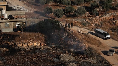 Israeli troops and settlers gather in the occupied West Bank, where Palestinians face almost daily violence. EPA