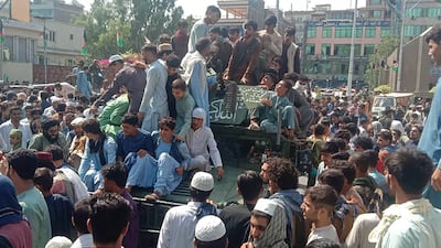 Taliban fighters sit on an Afghan Army Humvee in Jalalabad province.