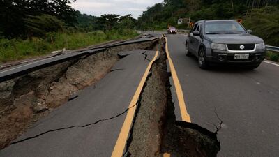 A vehicle rolls on a cracked route after the earthquake in Chone, Ecuador. Juan Cevallos / AFP Photo