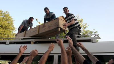 Iraqis unload the coffin of a relative yesterday a day after a car bomb in the Karrada area of Baghdad killed 12 people. Ahmad Al Rubaye / AFP