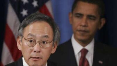 Barack Obama listens as Energy Secretary nominee Steven Chu addresses the media in Chicago.