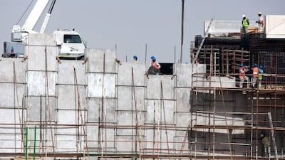 Britain’s Queen Elizabeth II's trip is a symbol of the solid economic ties between the two nations. Above, workers with the UK-based Halcrow construction company built Sheikh Khalifa Highway.