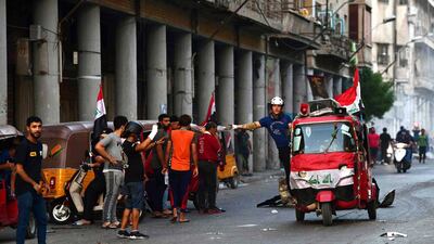 Iraqi protesters ride tuk-tuk during clashes with protesters and riot police forces near al-Ahrar bridge (The Freemen Bridge) in central Baghdad, Iraq. EPA