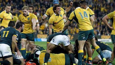 Australia celebrate after scoring the game-winning try against South Africa in their Rugby Championship opener on Saturday. Jason Reed / Reuters / July 18, 2015