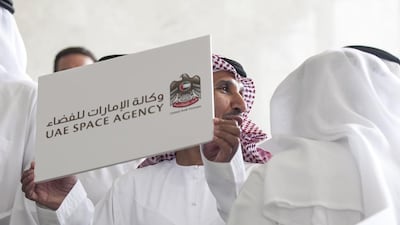 Mohamed Al Ahbabi holds up a sign as he and other guests pose after a press conference announcing The National Space Programme,. Silvia Razgova for The National