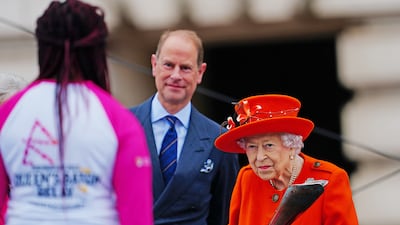 Queen Elizabeth II passes the baton to British parasport athlete Kadeena Cox, at the launch of the Queen's Baton Relay for the Birmingham 2022 Commonwealth Games, at Buckingham Palace. PA