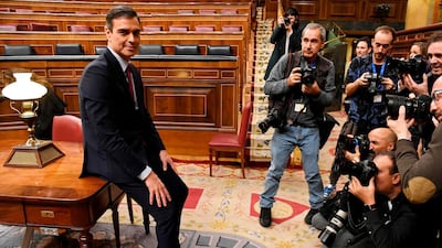 Pedro Sanchez poses for photographers after winning the vote. AFP
