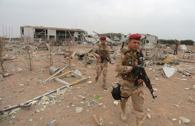 Iraqi army soldiers inspect the destruction at an airport complex under construction in Karbala, Iraq. AP