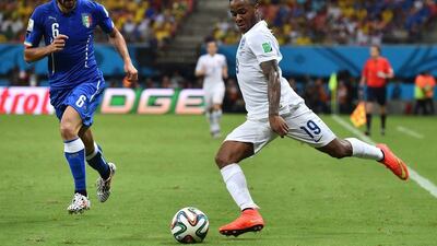 England midfielder Raheem Sterling prepares to play a cross as he's defended by Italy's Antonio Candreva during their 2014 World Cup Group D match on Saturday night in Manaus, Brazil. Ben Stansall / AFP