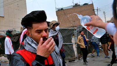 A protester affected by teargas receives first aid during clashes between security forces and anti-government protesters in central Baghdad. AP Photo