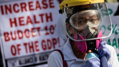 A health worker joins a protest calling for better government response amid the coronavirus outbreak, as the one-year anniversary of the first COVID-19 case in the Philippines approaches, outside a government hospital in Quezon City, Metro Manila, Philippines. Reuters