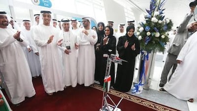 A robot built by female Khalifa University students cut the ribbon for Expo Science International, as Sheikh Mansour bin Zayed, Deputy Prime Minister and Minister for Presidential Affairs, watched on. Fatima Al Marzooqi / The National