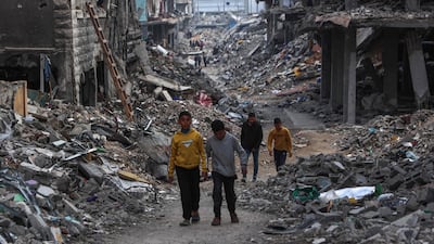 Palestinians walk in a neighbourhood in Beit Lahia, in the northern Gaza Strip, devastated by Israeli air strikes. The Arab world faces a complex challenge in dealing with US President Donald Trump, whose approach to Middle East issues prioritises Israeli interests. AFP