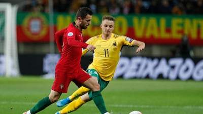 Bernardo Silva under pressure from Lithuania's Arvydas Novikovas. AP