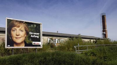 An election poster of Angela Merkel is displayed in front of a factory near Demmin, north east of Germany. September 14, 2005. AFP