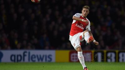 Arsenal’s Mesut Ozil takes a freekick during their Premier League match against Watford on Saturday. Paul Ellis / AFP
