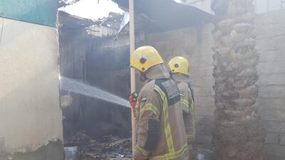 Fire fighters came to the aid of an elderly woman after a fire ripped through her home in Ras Al Khaimah. Courtesy Ras Al Khaimah Civil Defence