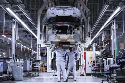 Workers secure chassis fittings on a Volkswagen electric automobile at a factory in Zwickau, Germany. Global electric car sales were predicted to take up a record share of the car market of more than 3 per cent in 2020. Bloomberg