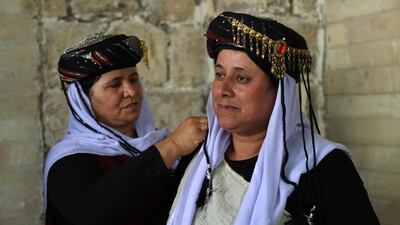 Iraqi Yezidi women visit the Temple of Lalish, in a valley near the Kurdish city of Dohuk about 430km northwest of the capital Baghdad, on July 16, 2019. AFP