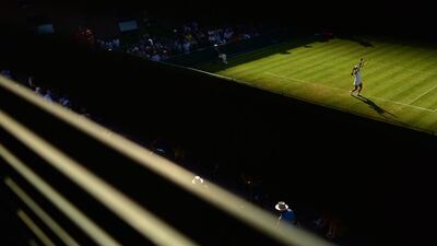 Lauren Davis serves against Polona Hercog during their first round match at Wimbledon on Monday. Leon Neal / AFP